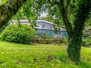 A house with a deck, surrounded by greenery and trees. - 2 Bed in Parkham (oc-78252) (Parkham)