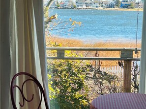A room with a view of a beach and water.
