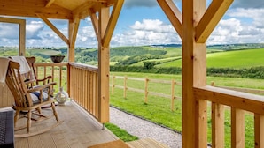 A wooden deck with a view of rolling hills. - 1 Bed in Torpoint (oc-78680) (Deviock)