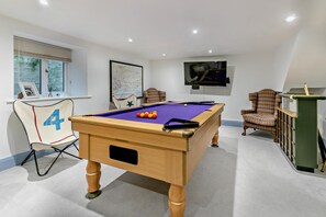 A pool table with balls, a chair marked with the number 4, a television, and a window with blinds. - 5 Bed in Fowey (oc-72387) (Polruan)