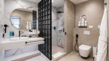 A modern bathroom with a vanity, a shower, and a toilet.