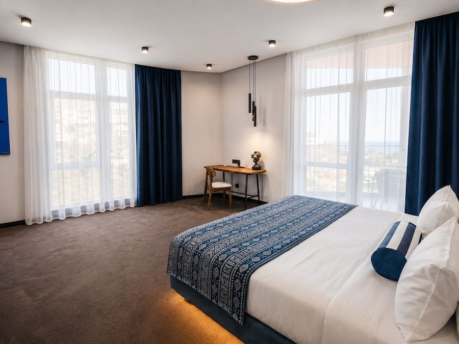 Deluxe Triple Room, Sea View | Premium bedding, minibar, in-room safe, desk