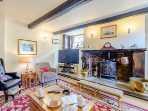 A living room with a fireplace, television, and seating area. - 5 Bed in Wareham (oc-dc032) (West Lulworth)