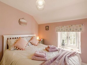 A bedroom with a bed, pillows, a bedside table, a lamp, a window with curtains, and a wall-mounted light fixture. - 2 Bed in Otley (oc-75268) (Lindley)