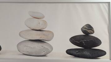 A framed photograph of three stacks of stones.