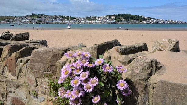 A beach with a stone wall in the foreground and a town in the background. - 2 Bed in Bideford (oc-77292) (Bideford)