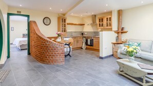 A spacious living area with a kitchen, a dining area, and a staircase leading to a bedroom. - 2 Bed in Bideford (oc-77292) (Bideford)