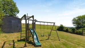 A playground with a slide and swings. - 5 Bed in Wellington (oc-77900) (Ashbrittle)