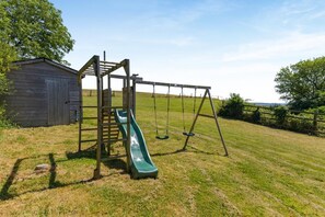 A playground with a slide and swings.