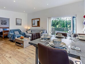 A modern living room with a dining area, a sofa set, and a view of the outdoors. - 2 Bed in Camborne (oc-82635) (Camborne)