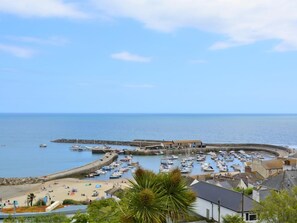 A coastal town with a marina, sandy beach, and buildings along the waterfront. - 2 Bed in Charmouth (oc-dc077) (Charmouth)