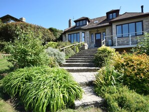 A stone staircase leading to a stone building with large windows and a garden with various plants. - 4 Bed in Swanage (oc-dc020) (Studland)