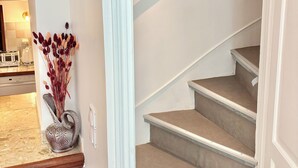 A staircase with a light-colored carpet and a dark handrail. - Family home close to the beach and town centre (Trouville-sur-Mer)