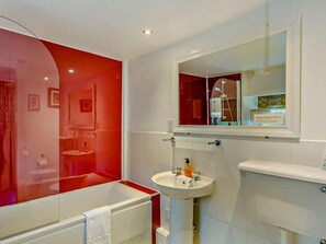 A bathroom with a red accent wall, a white sink, and a mirror above it. - 2 Bed in Lamplugh (oc-sz418) (Lamplugh)