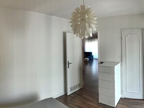 A room with a white door, a white cabinet, and a ceiling light fixture. - Bright apartment near center and beaches (Cannes)