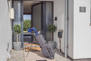 A doorway leading to a room with a visible window, a door, and a small potted plant. - 4 Bed in Bideford (oc-75358) (Northam)