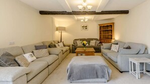 A living room with two sofas, a coffee table, a lamp, and a bookshelf. - 7 Bed in Bideford (oc-85428) (Woolfardisworthy)