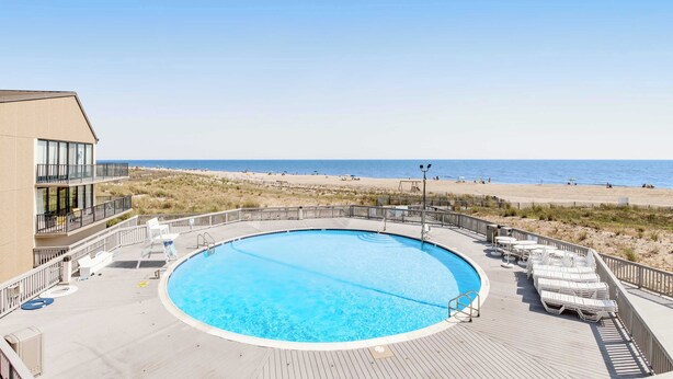 Una piscina con vista a la playa y al océano.