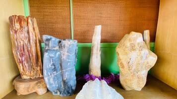 A collection of stone sculptures on a wooden shelf.