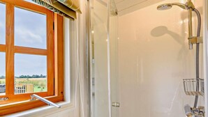 A shower with a handheld showerhead, a glass door, and a window with a wooden frame. - 1 Bed in Market Rasen (oc-83847) (Faldingworth)