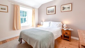 A bedroom with a bed, bedside tables, a window with curtains, and framed pictures on the wall. - 2 Bed in Workington (oc-sz331) (Lamplugh)