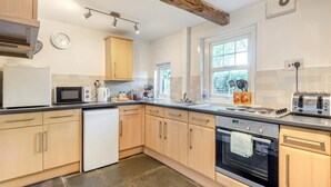 A modern kitchen with light wood cabinets, a microwave, a toaster, and a window providing natural light. - 2 Bed in Workington (oc-sz331) (Lamplugh)