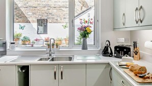 A kitchen with a window, sink, cabinets, and a toaster. - 2 Bed in Ashbourne (oc-85571) (Ashbourne)