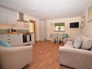 A compact living space with a kitchenette, a dining area, and a seating area with two sofas. - 2 Bed in Bristol (oc-75697) (Bristol)