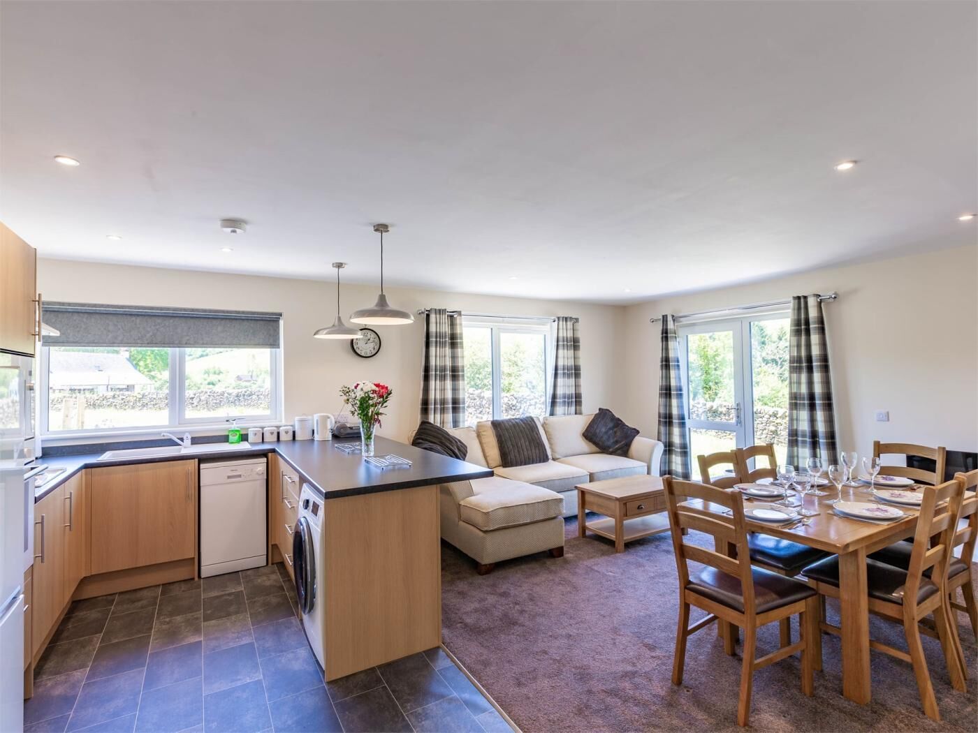 A compact living space with a kitchen, dining area, and seating.