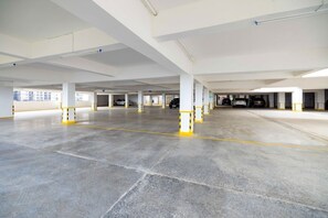 A large, empty parking garage with multiple levels and columns. - 1 Bedroom Apartment 15 Min to JKIA & SGR with Nairobi National Park Views (Nairobi)