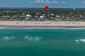 An aerial view of a coastal area with a beach, ocean, and residential buildings. - Emerald Isle Beach Retreat | Ping Pong | Sleeps 8 (Emerald Isle)