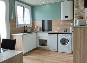 A modern kitchen with a built-in oven, dishwasher, and washing machine. - The Seagulls of the Shore (Saint-Jean-de-Monts)