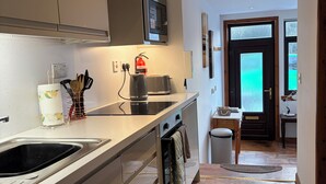 A modern kitchen with a built-in oven, a microwave, and a stovetop.