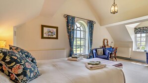 A bedroom with a bed, a desk, a chair, and a window with curtains. - 1 Bed in Brecon (oc-bn129) (Yscir)