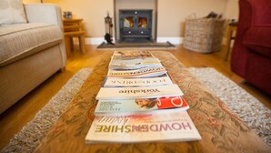 A living room with a sofa, a fireplace, a television, and a magazine rack. - 1 Bed in Howden (oc-g0181) (Saltmarshe)