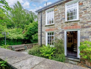 A stone building with a wooden bench, a garden, and a staircase leading to the entrance. - 2 Bed in Llandysul (oc-85444) (Felindre)