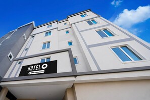 A modern hotel building with a sign that reads 'HOTEL OYO-Serviced'. - Classic Hotel O SLN Gachibowli (Hyderabad)
