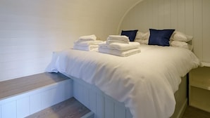A bedroom with a bed, pillows, and folded towels. - 1 Bed in Girvan (oc-78073) (Girvan)