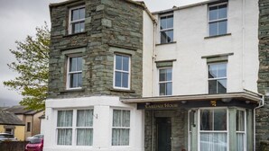 A two-story building with a stone facade and a white lower section. - 2 Bed in Keswick (oc-sz215) (Keswick)