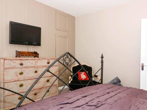 A bedroom with a bed, a dresser, a television mounted on the wall, and a door. - 5 Bed in Hurst Green (oc-46916) (Robertsbridge)