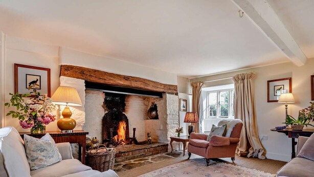 A cozy living room with a fireplace, comfortable seating, and a view of the outdoors. - 5 Bed in Sturminster Newton (oc-76458) (Woodrow)
