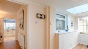 A modern kitchen with a skylight, a view to the outside, and a decorative clock on the wall. - 3 Bed in Freshwater (oc-79039) (Freshwater)