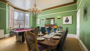 A dining room with a pool table, a chandelier, and a green wall. - 5 Bed in Melrose (oc-79418) (Melrose)