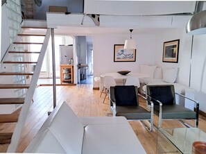 A modern interior with a staircase, a dining area, and a living room. - Downtown apartment with beautiful terrace and air conditioning- BENAKEY (Cannes)