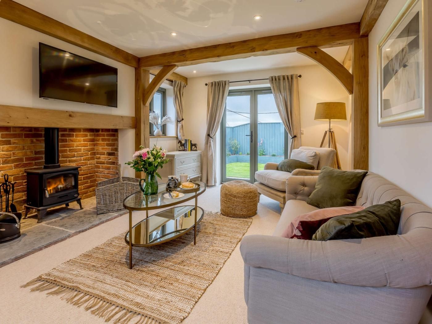 A cozy living room with a fireplace, a sofa, a coffee table, and a television.