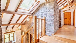 Eine Holztreppe mit Steinwänden und einer Holztür.