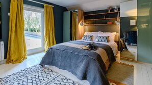 A bedroom with a bed, yellow curtains, a bedside table, a lamp, and a window. - 2 Bed in Ashbourne (oc-80458) (Parwich)