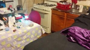 A kitchen with a stove, sink, and wooden cabinets. - Perfect 2-bedroom apartment with AC in charming Bronx neighborhood (Bronx)