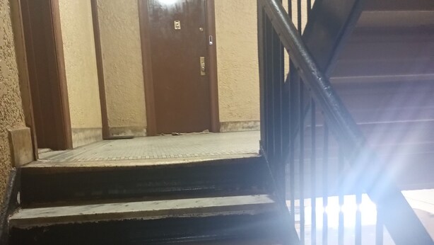 A staircase with a handrail, a door with a 'No Smoking' sign, and a checkered floor. - Perfect 2-bedroom apartment with AC in charming Bronx neighborhood (Bronx)