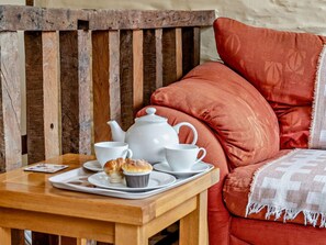 A wooden table with a tray holding a teapot, cups, and a muffin. - 1 Bed in Brecon (oc-bn367) (Bwlch)